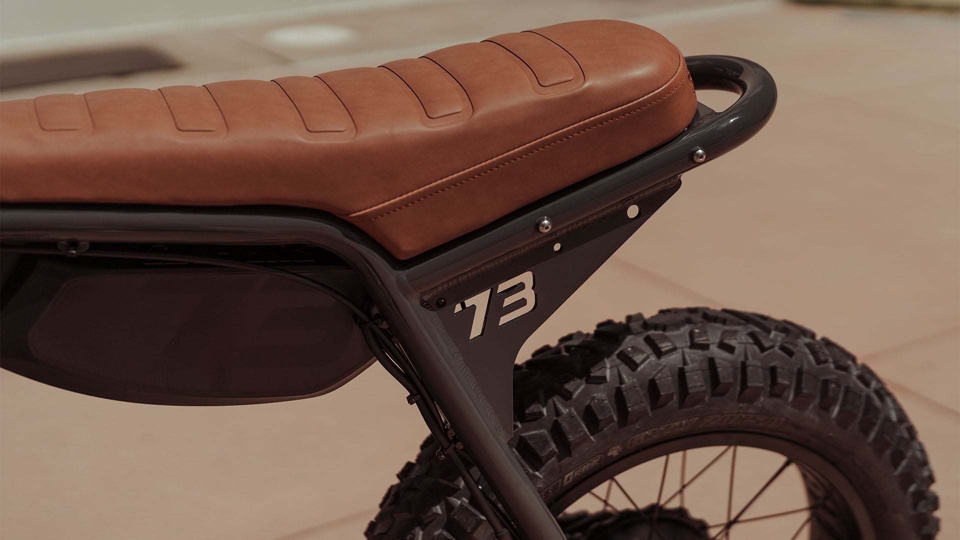 Close-up image of the seat and rear tire of the SUPER73-ZX SE ebike in Palladium