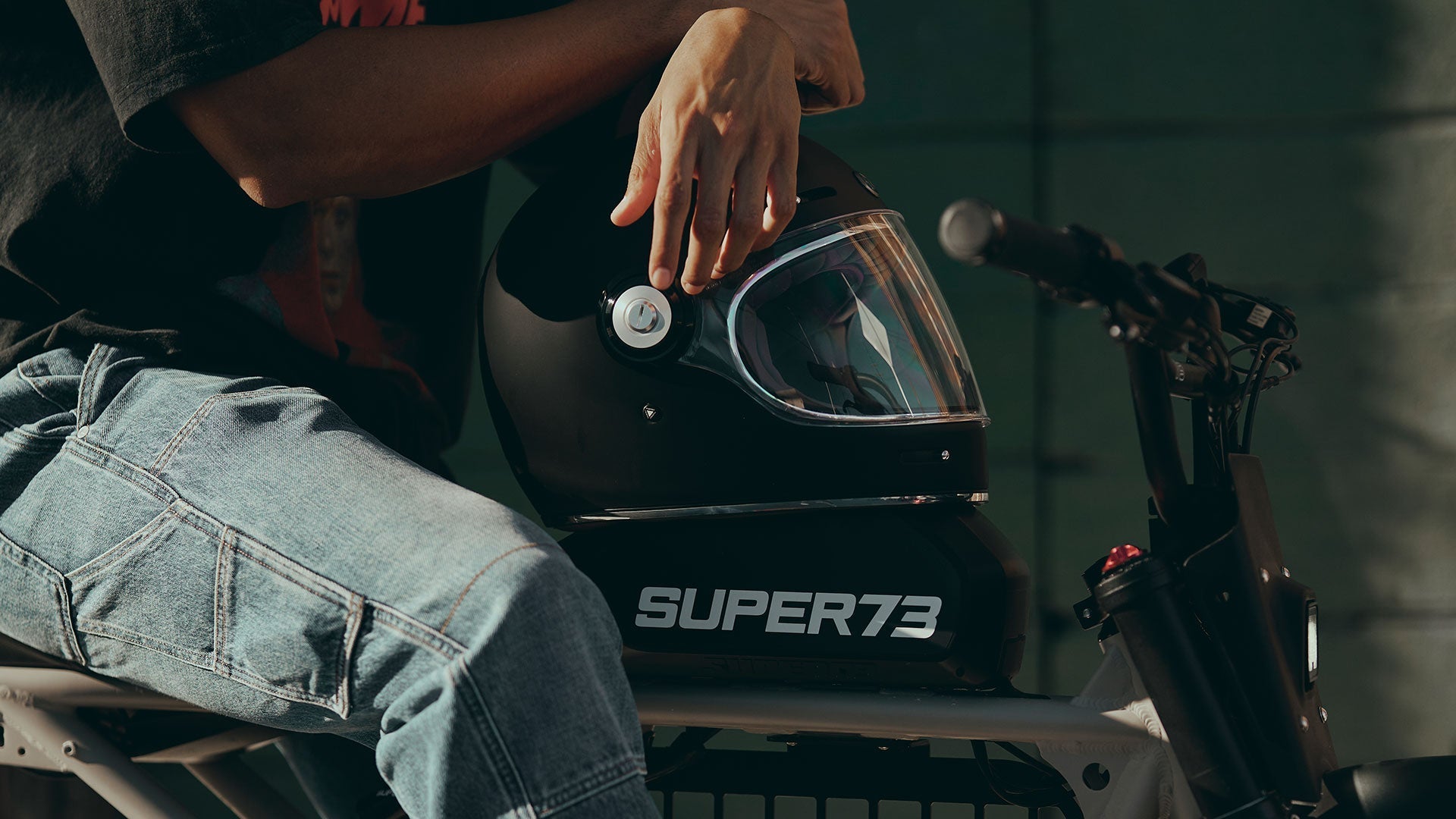 rider with helmet sitting on a super73