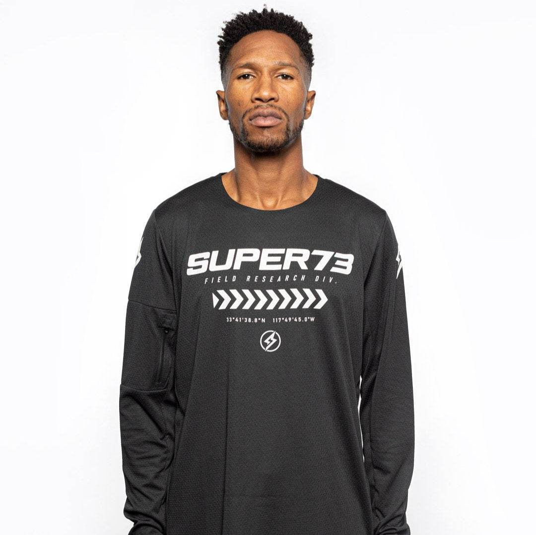 Male model front view of black Premium long sleeve athletic moto hoon jersey. @color_black