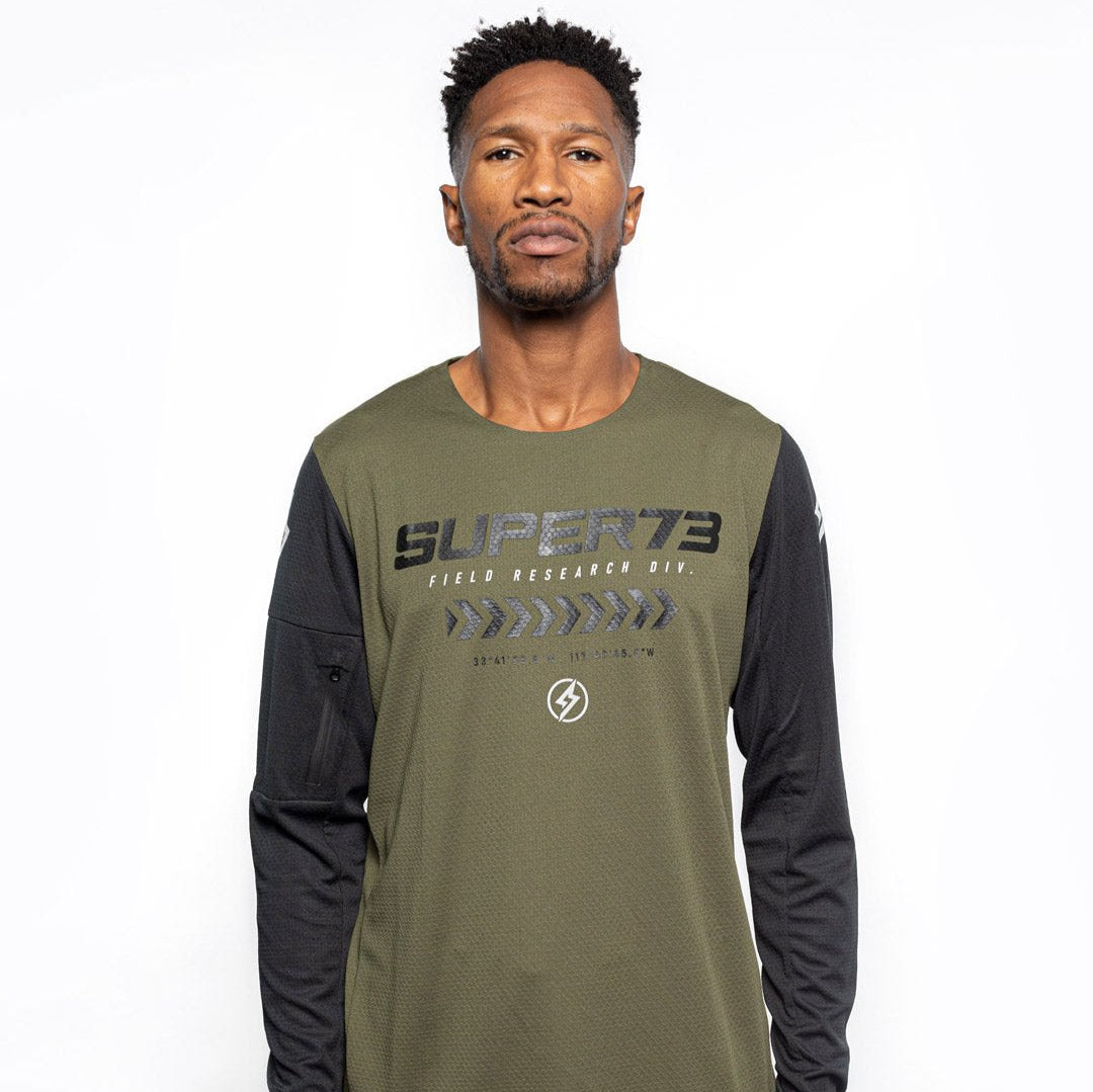 Male model front view of black and olive Premium long sleeve athletic moto hoon jersey. @color_dark fatigue