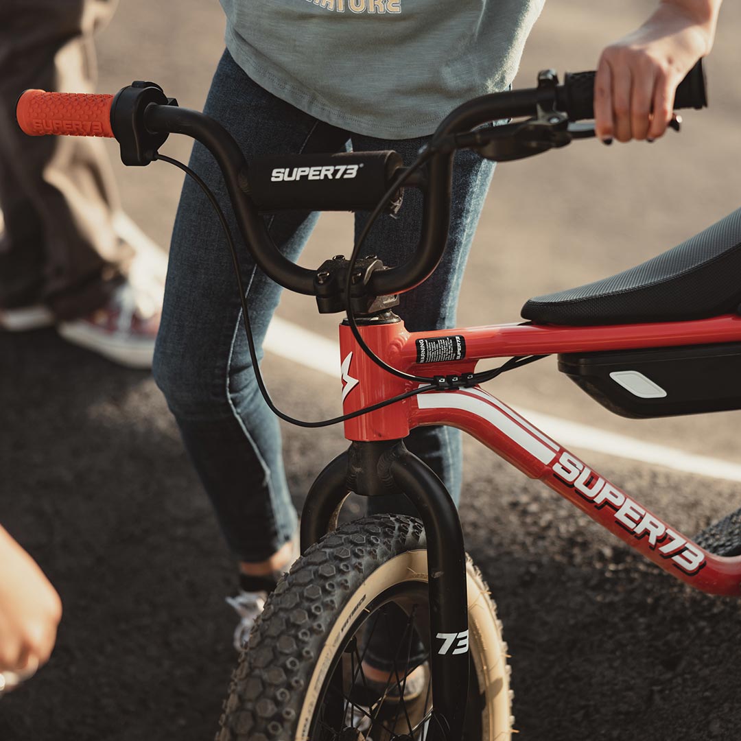 lifestyle image of a kid next to their K1D showcasing the K1D Big Trouble Handlebar on K1D