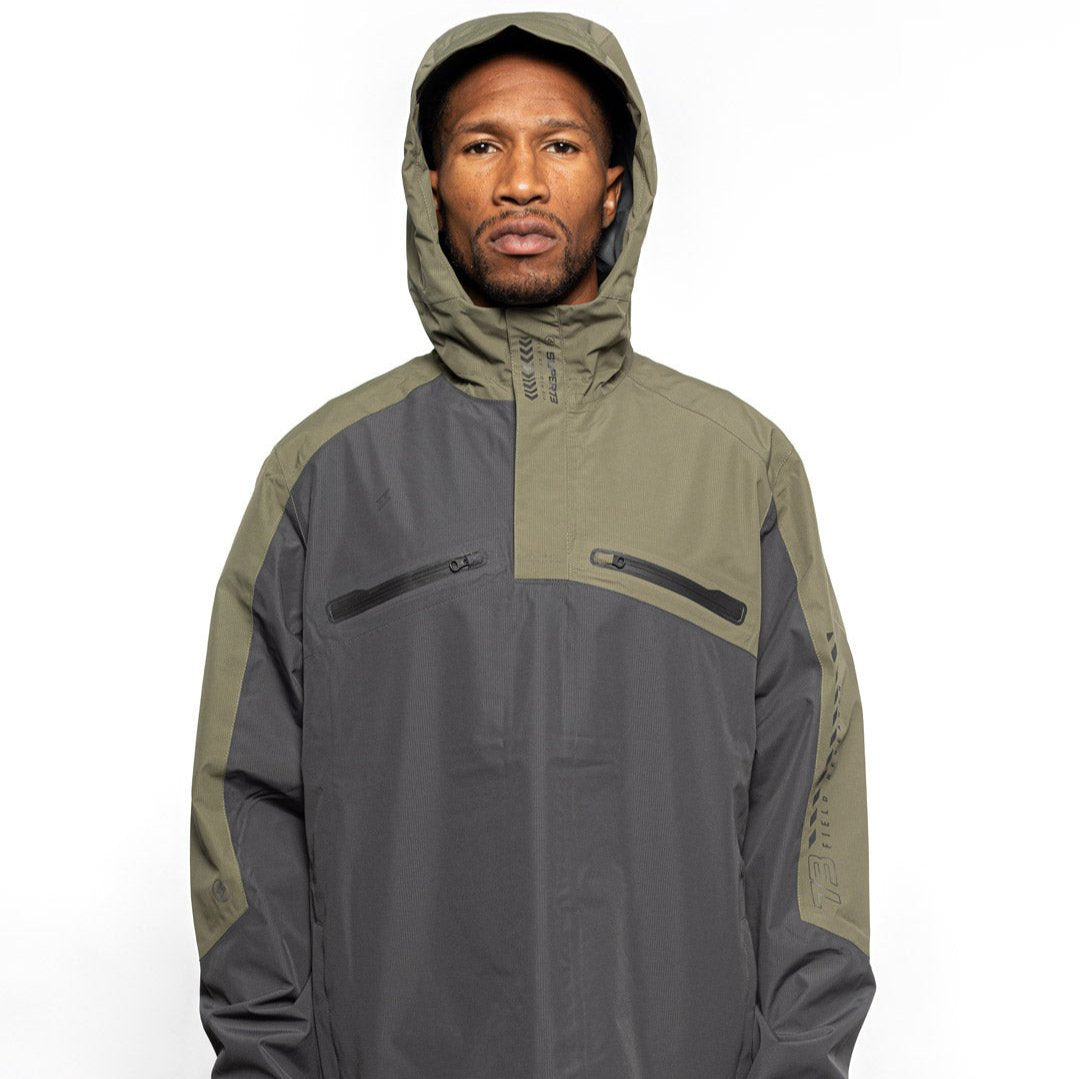 Male model wearing Vale Packable Anorak in Dark Fatigue colorway with hood on. @color_dark fatigue